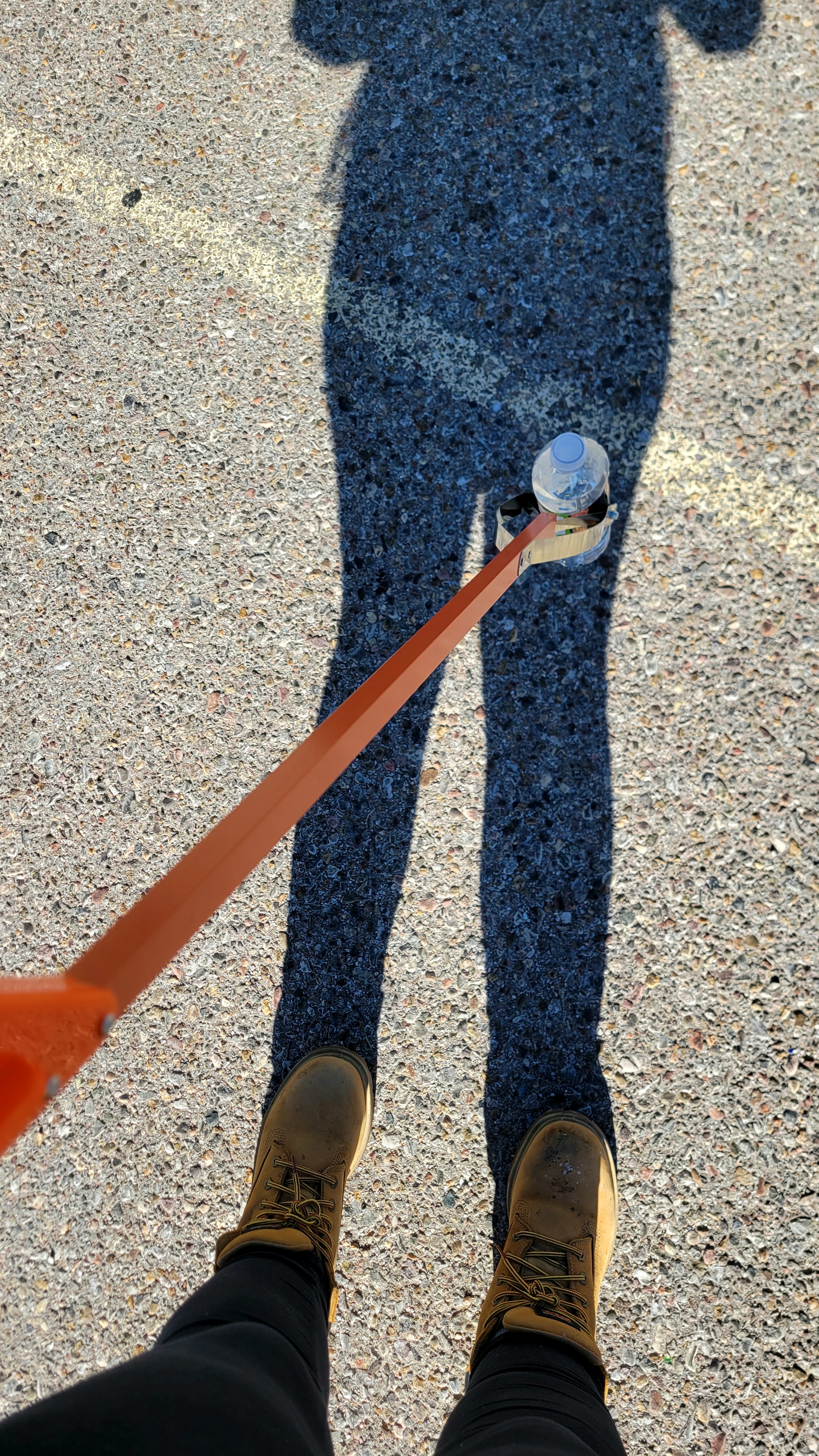 Trash picker grabbing a water bottle.